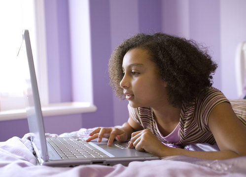 biracial girl on laptop