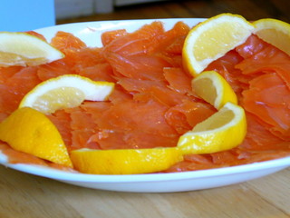 platter of smoked salmon and lemon wedges