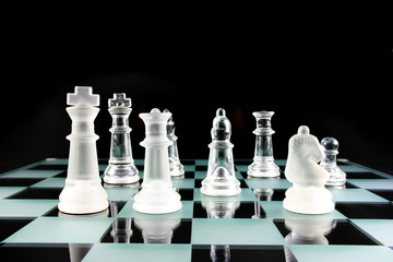 chess pieces on a glass board
