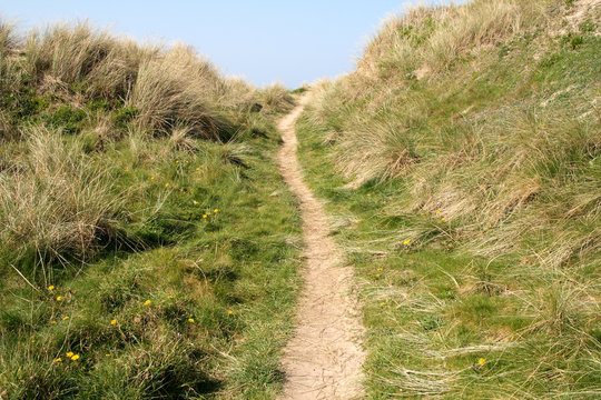 a path to the beach in perranporth, cornwall, uk.
