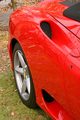 side of red supercar