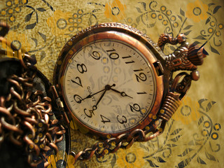 Fototapeta na wymiar old clock on vintage background with flowers
