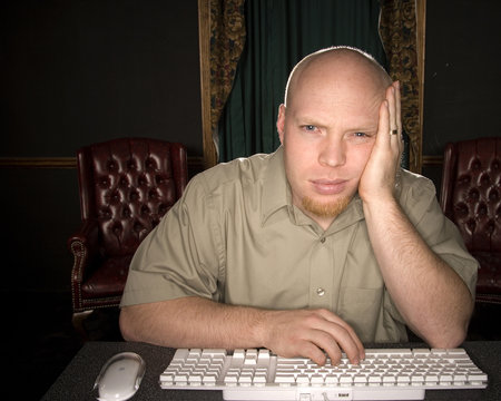 bored man looking at computer