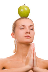 beautiful blond girl with a green apple on her head