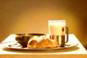sepia picture of a healthy breakfast (focus on croissante)