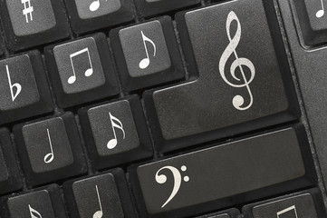 the keyboard of a computer with notes.