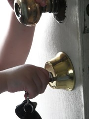 child putting keys in a lock