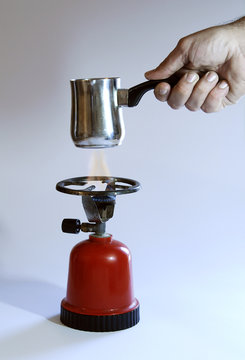 a hand hold a coffee-pot