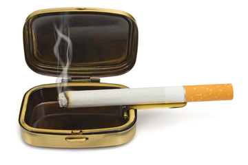smoking cigarette in compact ashtray