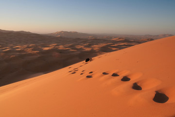 footsteps in erg chebbi sand dunes