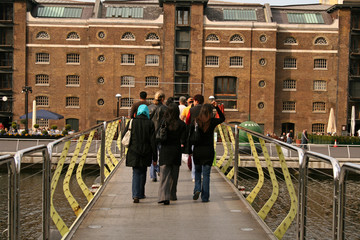 people crossing bridge
