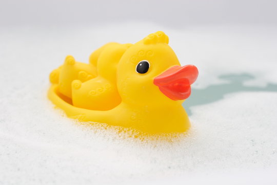 three rubber ducks in foam water #5