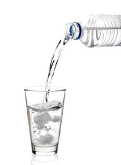 bottled water being poured into a glass