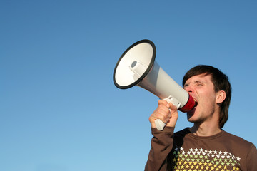 young man shouting through megaphone