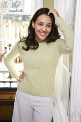 smiling woman leaning and looking at viewer.