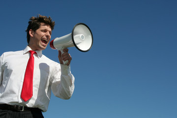 businessman shouting through megaphone