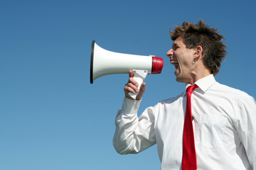 businessman shouting through megaphone