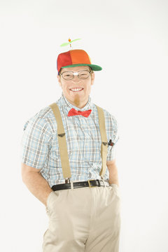 young man dressed like nerd with hands in pockets.