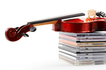 violin lying down on cds on white background