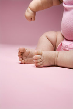 close up of babys legs and arm.