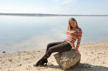 Fototapeta na wymiar girl sitting on a stone