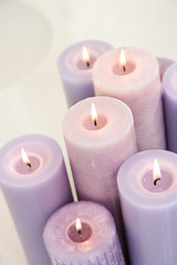 Obraz na płótnie Canvas Close up of lit lavendar candles.