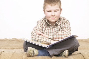 little boy reading a book