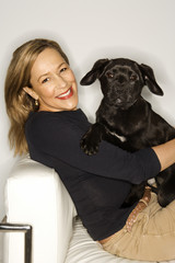 Woman with black puppy.