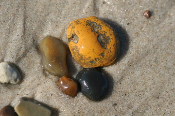 steine am strand in orange braun und schwarz