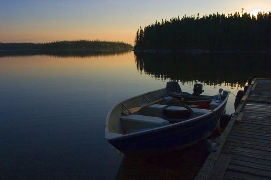 Calm waters at sunrise at a lake in Canada begging fishermen to get out for the early fishing bite