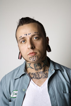 Adult Male With Tattoos And Piercings.