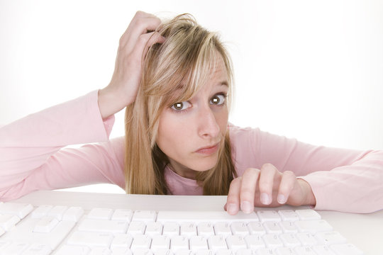 confused teenage girl using computer