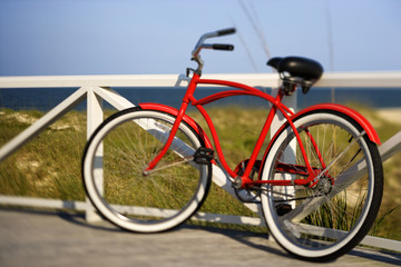Fototapeta na wymiar Bicycle leaning against rail on Bald Head Island, North Carolina