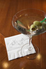 Martini with napkin reading "get lost."
