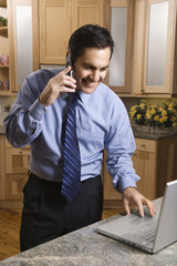 Businessman on cellphone and laptop.