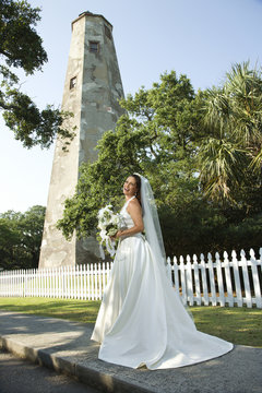 Bride with lighthouse in background.