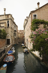 Canal with boats and buildings in Venice, Italy.