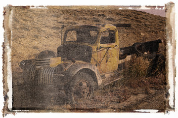 polaroid transfer of old pickup abandoned on hill.