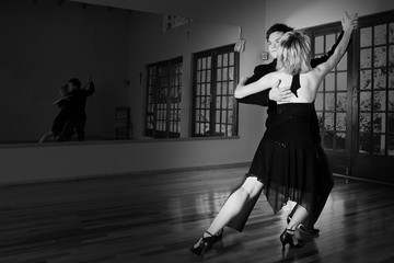 two ballroom dancers practicing in their studio