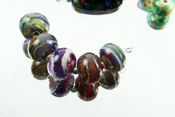 five colorful glass beads strung together