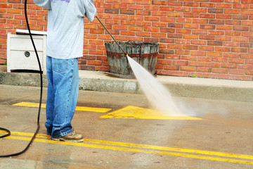 a crew member cleans the painted street markings