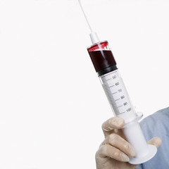 male holding a syringe.