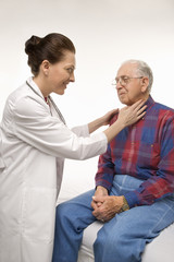 doctor checking an elderly man's pulse.