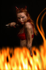 dark red devil girl with a knife in fire