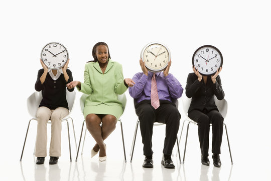 business people covering faces with clocks and businesswoman shr