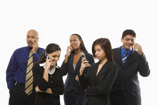business group of men and women talking on cell phones.