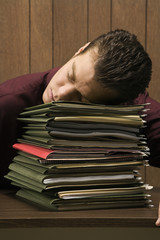 overworked retro businessman sleeping at desk.