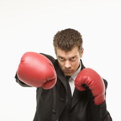 man in suit wearing boxing gloves.