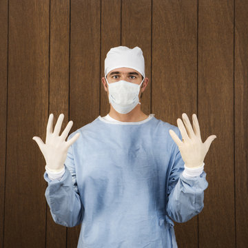 Male Surgeon Wearing Mask And Gloves.