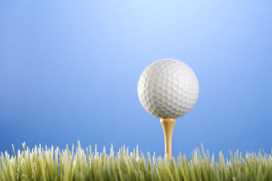 golfball on a tee in grass.